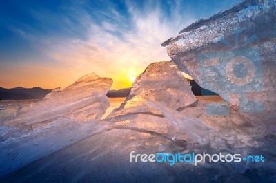 Very Large And Beautiful Chunk Of Ice At Sunrise In Winter Stock Photo