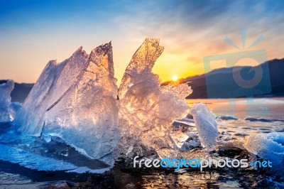 Very Large And Beautiful Chunk Of Ice At Sunrise In Winter Stock Photo