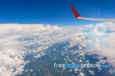 View From Airplane Window. Wing Of An Airplane Flying Above The Stock Photo