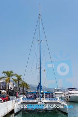 View Of A Catamaran In The Harbour At Porto Banus Stock Photo