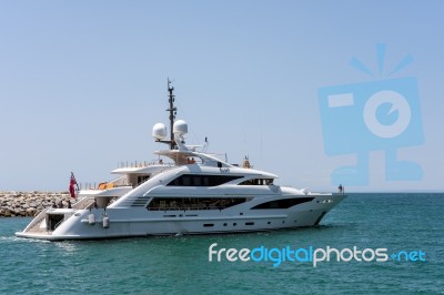 View Of A Luxury Yacht Leaving The Harbour At Porto Banus Stock Photo