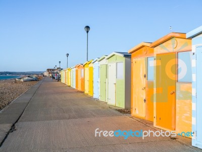 View Of Beach Huts On Seaford Promenade In Sussex Stock Photo