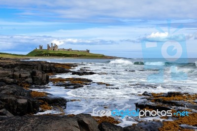 View Of Dunstanburgh Castle At Craster Northumberland Stock Photo