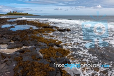 View Of Dunstanburgh Castle At Craster Northumberland Stock Photo