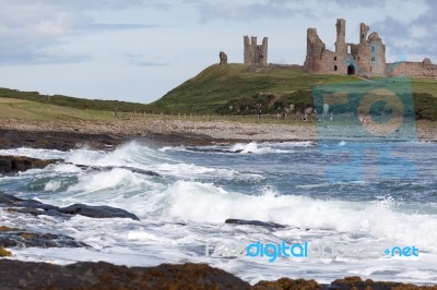 View Of Dunstanburgh Castle At Craster Northumberland Stock Photo