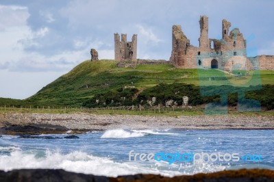 View Of Dunstanburgh Castle At Craster Northumberland Stock Photo