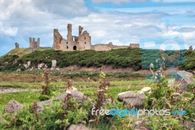 View Of Dunstanburgh Castle At Craster Northumberland Stock Photo