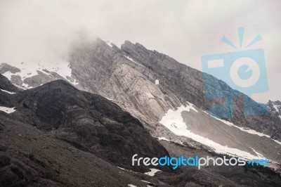 View Of Jade Dragon Snow Mountain With Cloudy In Lijiang ,china Stock Photo