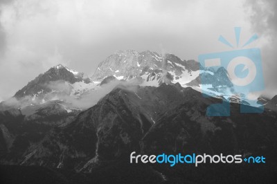 View Of Jade Dragon Snow Mountain With Cloudy In Lijiang ,china Stock Photo