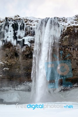 View Of Seljalandfoss Waterfall In Winter Stock Photo