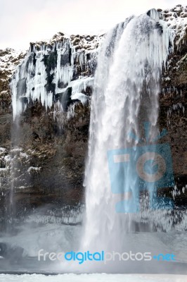 View Of Seljalandfoss Waterfall In Winter Stock Photo