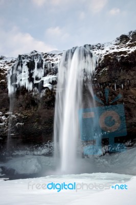 View Of Seljalandfoss Waterfall In Winter Stock Photo