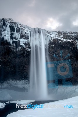 View Of Seljalandfoss Waterfall In Winter Stock Photo