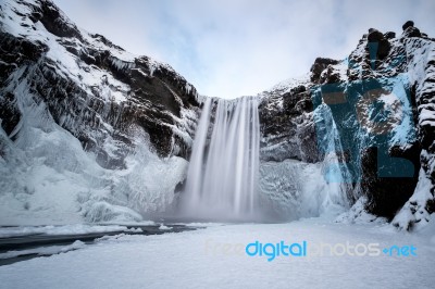 View Of Skogafoss Waterfall In Winter Stock Photo