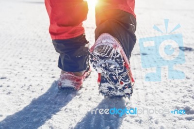 View Of Walking On Snow With Snow Shoes And Shoe Spikes In Winte… Stock Photo