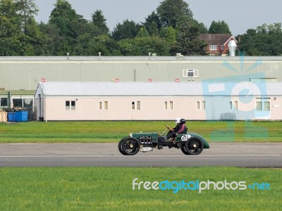 Vintage Car Driving Around Dunsfold Airfield Stock Photo