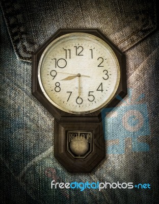 Vintage Clock On Jeans Background Stock Photo