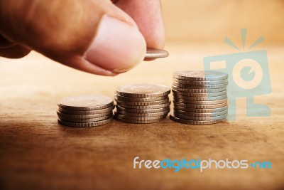 Vintage Close Up Of Hand Stacking Silver Coins Stock Photo