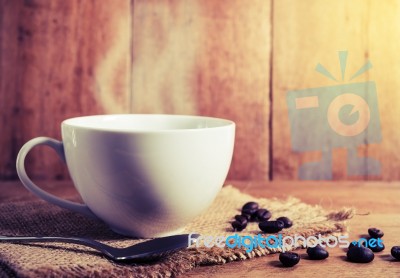 Vintage Coffee Cup And Bean On Table Stock Photo