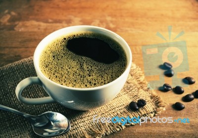 Vintage Coffee Cup With Bean On Table Stock Photo