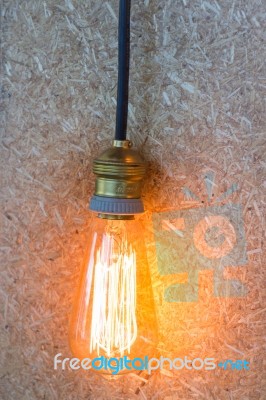 Vintage Hanging Light Bulb Decorated On Brown Wall Stock Photo