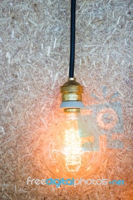 Vintage Hanging Light Bulb Decorated On Brown Wall Stock Photo