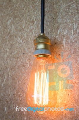 Vintage Hanging Light Bulb Decorated On Brown Wall Stock Photo