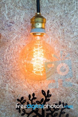 Vintage Hanging Light Bulb Decorated On Brown Wall Stock Photo