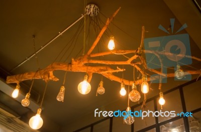 Vintage Hanging Light Bulb On Room Ceiling Stock Photo