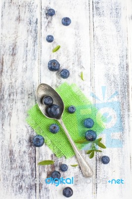 Vintage Spoon With Blueberries On White Wooden Table Stock Photo