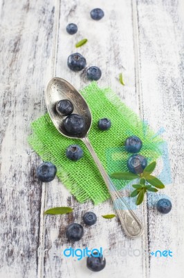 Vintage Spoon With Blueberries On White Wooden Table Stock Photo