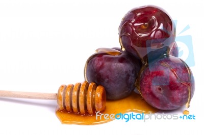 Violet Plums With Honey Dipper Stock Photo