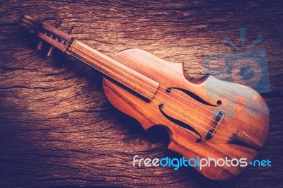 Violin On Grunge Dark Wood Background Stock Photo