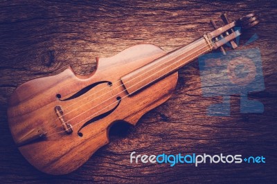 Violin On Grunge Dark Wood Background Stock Photo