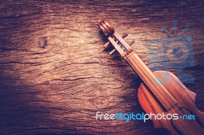 Violin On Grunge Dark Wood Background Stock Photo