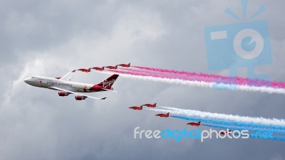 Virgin Atlantic Boeing 747-400 And Red Arrows Aerial Display At Stock Photo