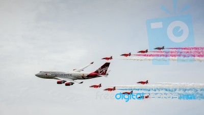 Virgin Atlantic Boeing 747-400 And Red Arrows Aerial Display At Stock Photo