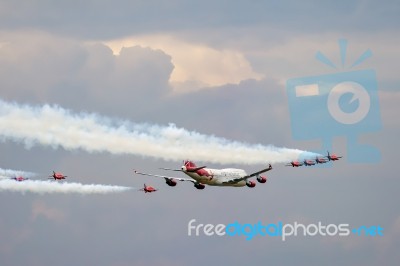 Virgin Atlantic Boeing 747-400 And Red Arrows Aerial Display At Stock Photo