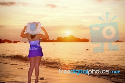 Visitors Woman Looking The Sunrise Over The Sea Stock Photo