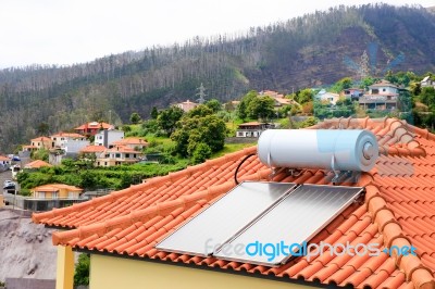 Water Boiler With Solar Panels On Roof Of House Stock Photo