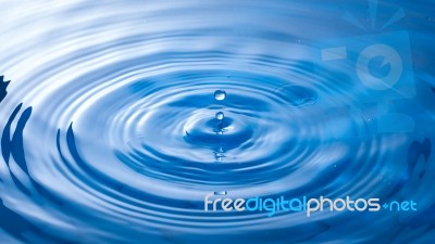 Water Drop Falling Into Water Making A Perfect Droplet Splash Stock Photo