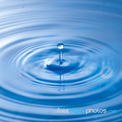 Water Drop Impact With Water Surface, Causing Rings On The Surface Stock Photo