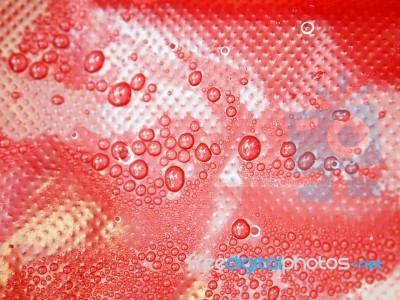 Water Drops On A Red Background Stock Photo