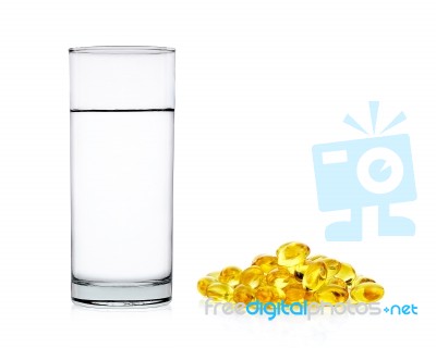 Water Of Glass With Fish Oil Capsules Isolated On The White Back… Stock Photo