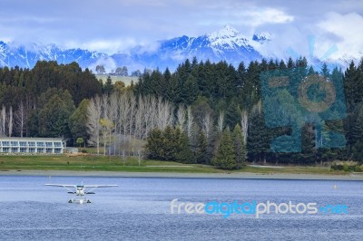 Water Plane Floating Over Fresh Water Lake Against Beautiful Mountain Scenery In Lake Te Anau New Zealand Stock Photo