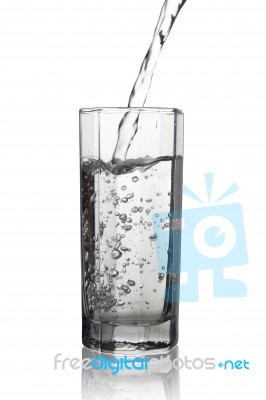 Water Pouring Into A Tall Glass With Its Reflection, Closeup Vie… Stock Photo