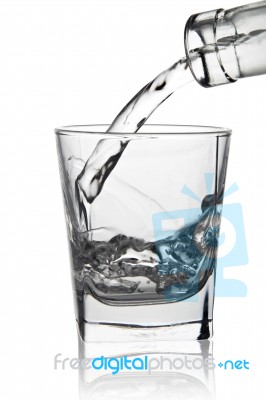 Water Pouring Into Glass, Close-up View, Isolated On White Stock Photo