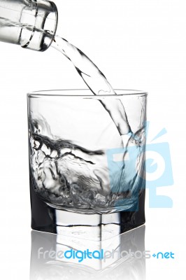 Water Pouring Into Glass With Its Reflection, Closeup View, Isol… Stock Photo