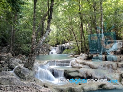 Waterfall Flowing Into The Water Is Blue Stock Photo