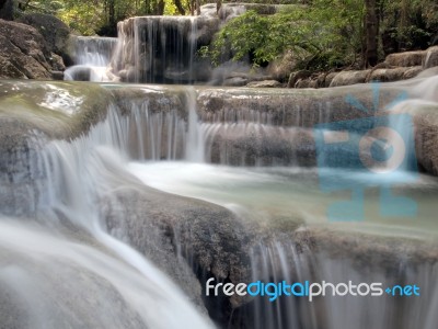 Waterfall With Water Flowing Around Stock Photo